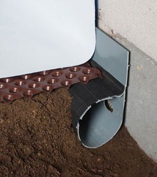 Closeup of a crawl space drainage system installed in Roberts Creek