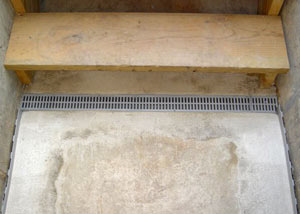 Our grated drain system installed on a leaking basement staircase in Roberts Creek.