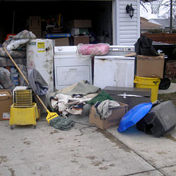 Soaked, wet personal items sitting in a driveway, including a washer and dryer in Courtenay.