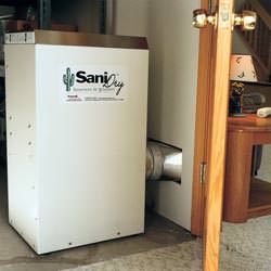 A basement dehumidifier with an ENERGY STAR® rating ducting dry air into a finished area of the basement  in Black Creek
