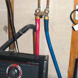 Washer hoses in a basement  in Gabriola