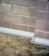 Our baseboard drain system installed on a corner in a Squamish basement.