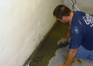 Restoring a concrete slab floor with fresh concrete after jackhammering it and installing a drain system in Gibsons.
